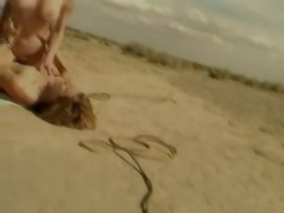 Busty blonde fucks outside on ground in vintage x rated clip
